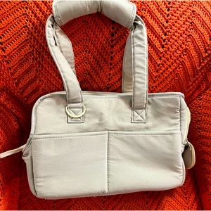 NWNT Onecute pet carrier,holds 1 small dog,3 spots for toys on front,2 on back